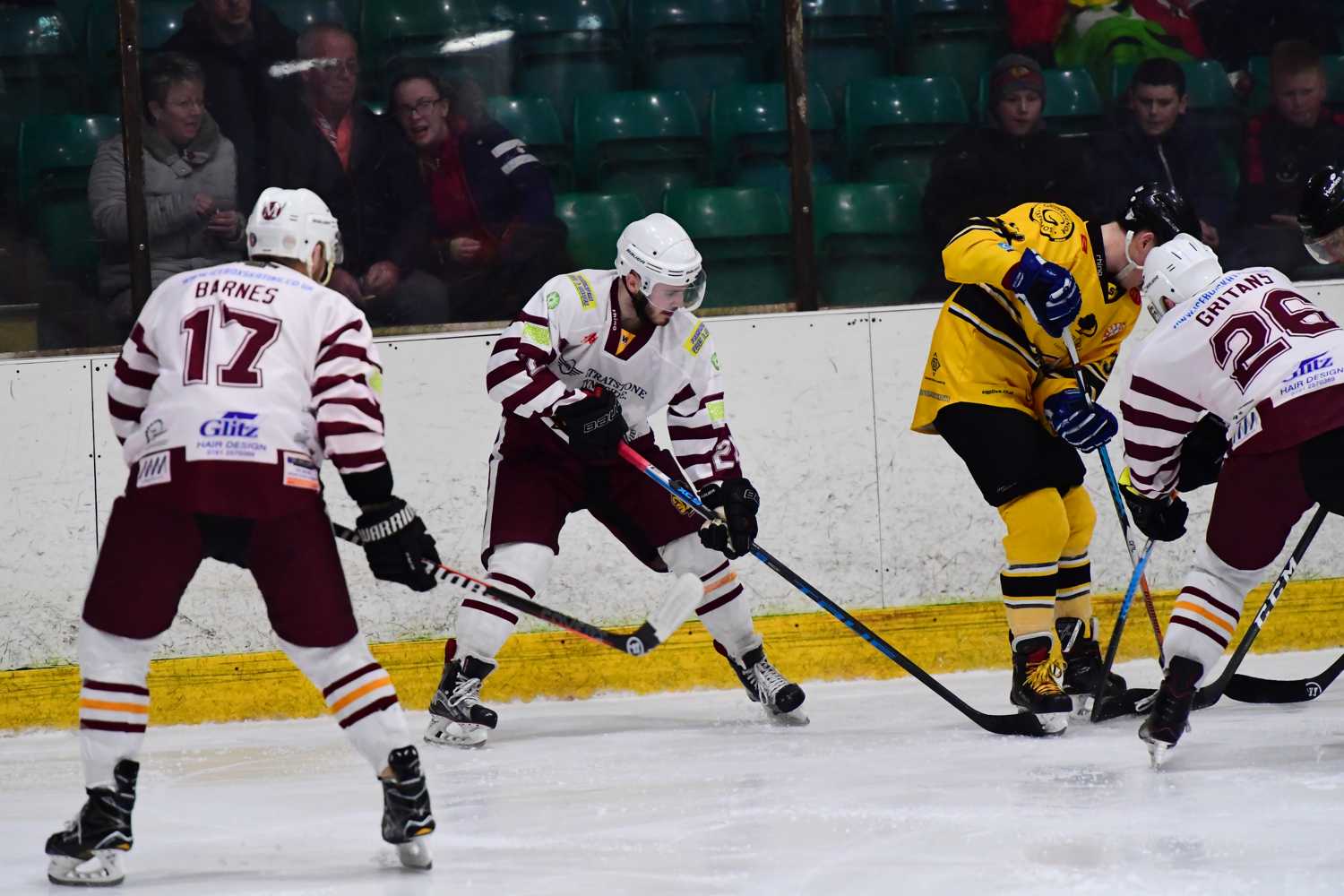 Gritāns and Harley dig the puck out with Barnes waiting