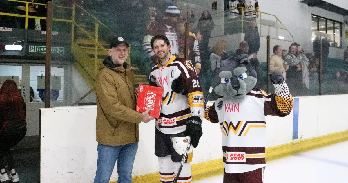 Warriors Captain Adam Wood receives his Man of the Match award from former player Mike Ware