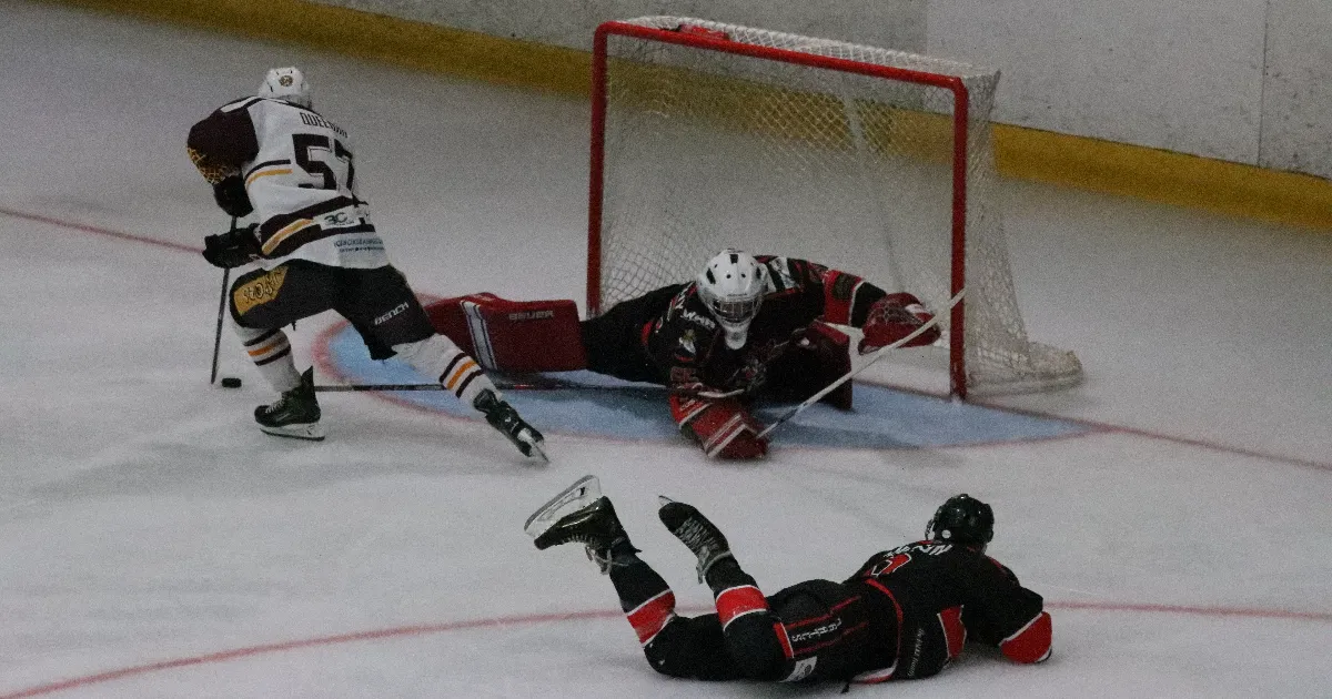 Callum Queenan takes the puck around netminder Callum Donaghy