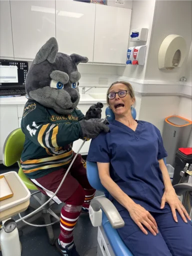Whitley Wolf giving dental treatment to a dentist